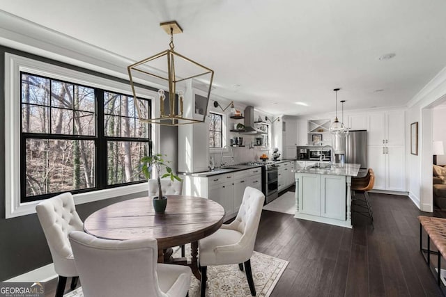 dining space featuring crown molding, baseboards, and dark wood-style flooring