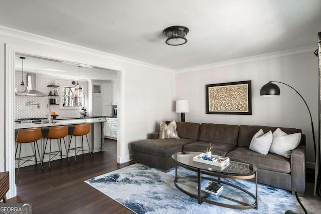 living area with crown molding, baseboards, and dark wood-style flooring