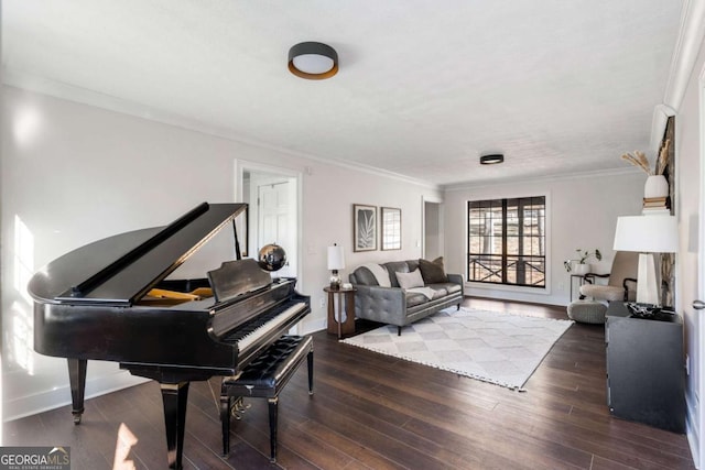 living area with crown molding, baseboards, and wood finished floors