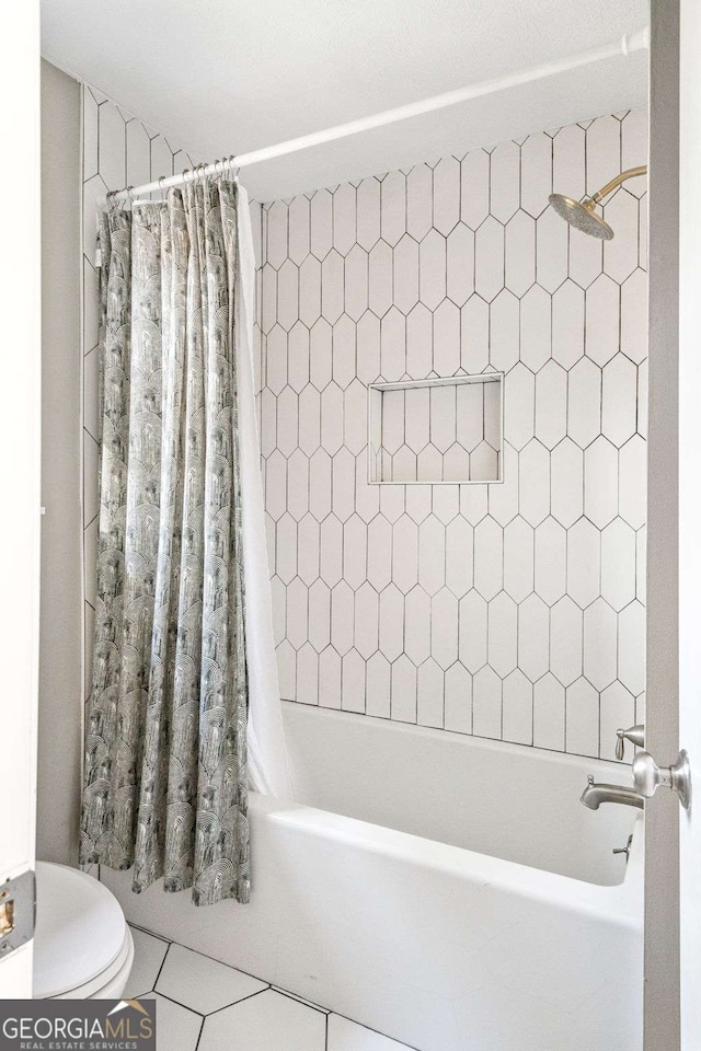 full bathroom featuring shower / tub combo, toilet, and tile patterned floors