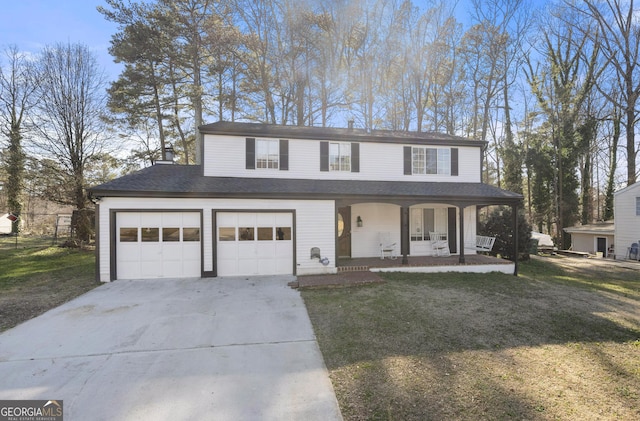 traditional home featuring a garage, a front yard, covered porch, and driveway