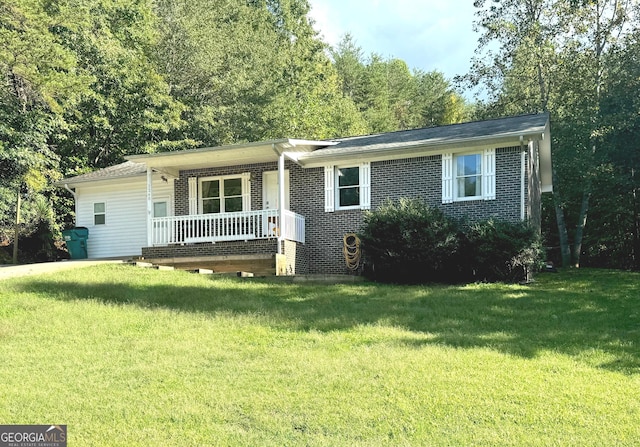 ranch-style house featuring a porch, a front yard, and brick siding