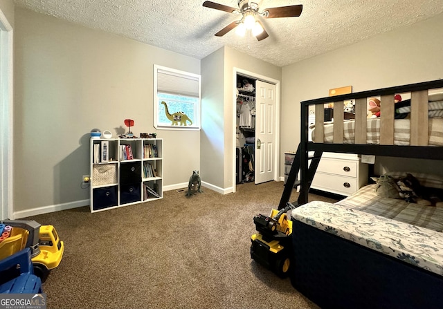 bedroom with dark colored carpet, a closet, ceiling fan, a textured ceiling, and baseboards