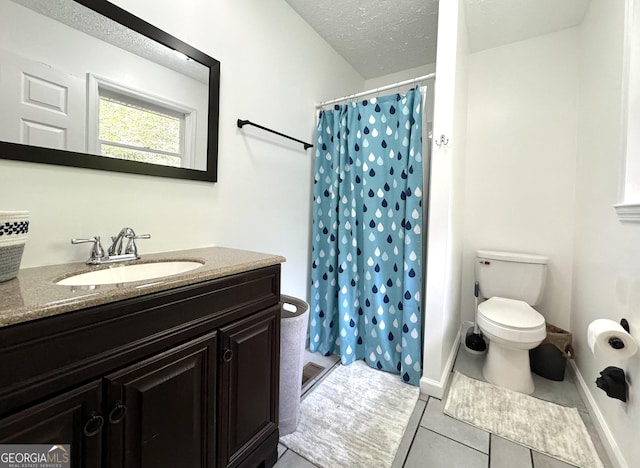 bathroom featuring toilet, curtained shower, a textured ceiling, and vanity