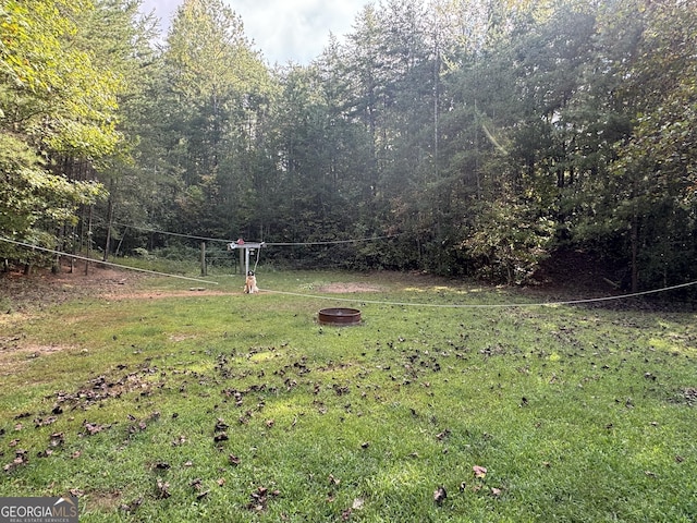 view of yard with a fire pit