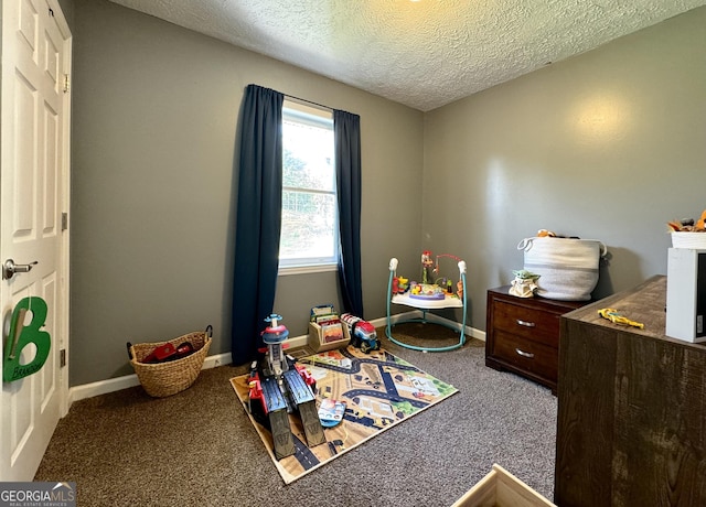 carpeted bedroom with baseboards and a textured ceiling