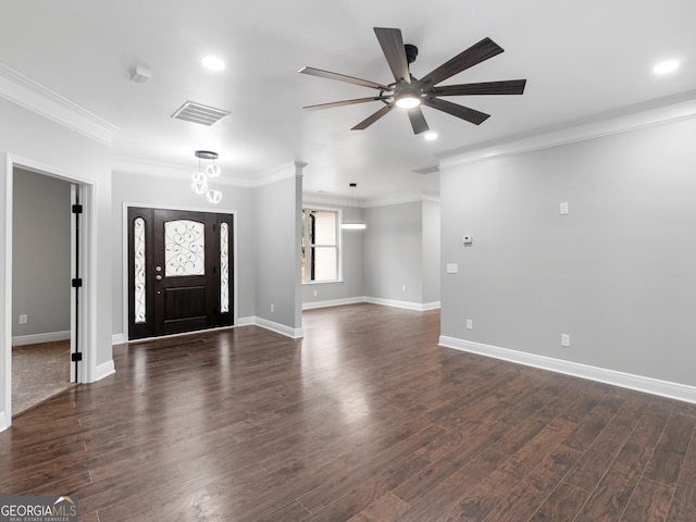 foyer with dark wood finished floors, visible vents, crown molding, and baseboards