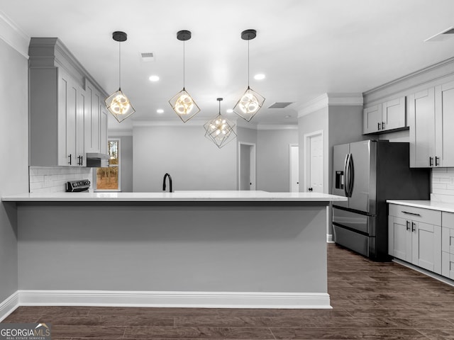 kitchen featuring a peninsula, gray cabinetry, light countertops, and stainless steel fridge with ice dispenser