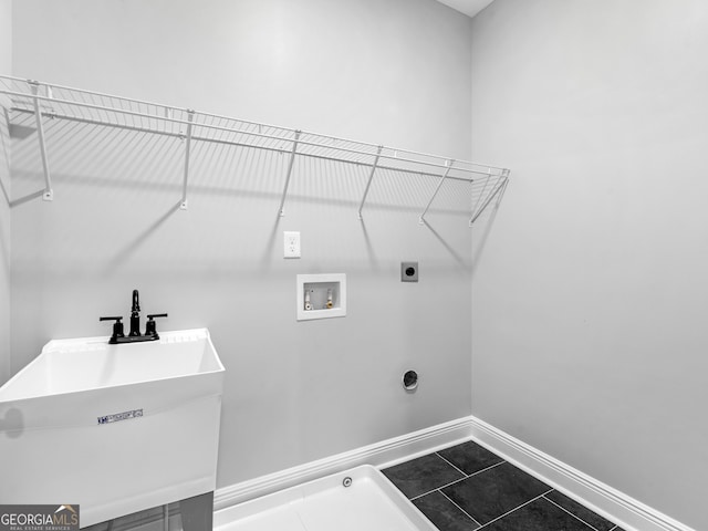 washroom with washer hookup, a sink, electric dryer hookup, laundry area, and baseboards