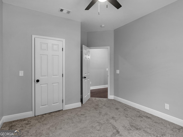 unfurnished bedroom featuring light colored carpet, visible vents, and baseboards