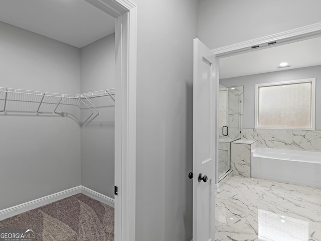 full bath featuring a marble finish shower, baseboards, marble finish floor, a garden tub, and a spacious closet