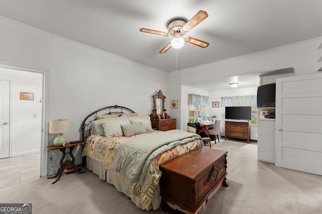 bedroom featuring light carpet, crown molding, and a ceiling fan