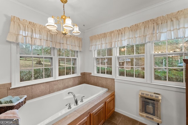 full bathroom featuring tile patterned floors, heating unit, a garden tub, crown molding, and a chandelier