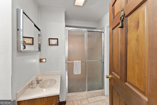 full bathroom with a stall shower, tile patterned flooring, crown molding, and vanity