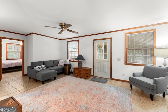 living room featuring ornamental molding, a ceiling fan, and light tile patterned flooring