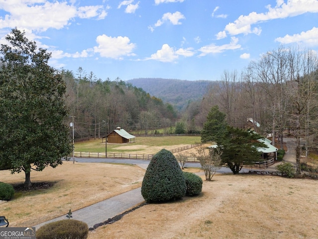 exterior space featuring a rural view and a wooded view