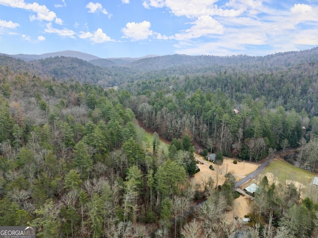 aerial view with a mountain view and a wooded view