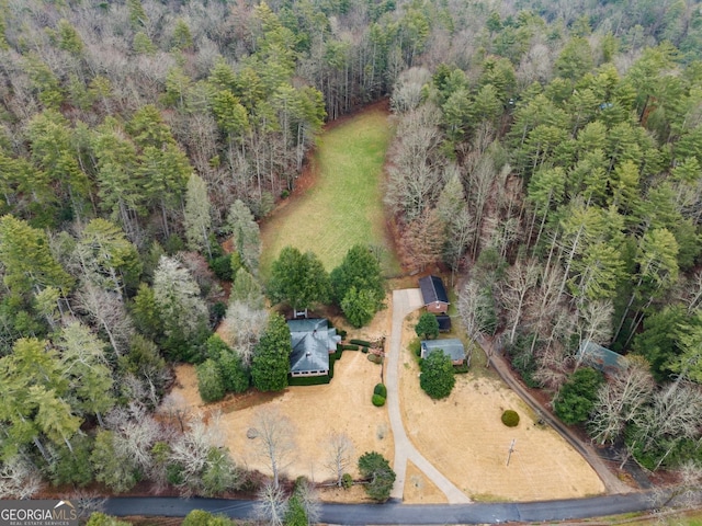 birds eye view of property with a forest view