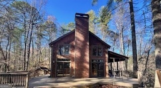 view of side of home featuring a chimney