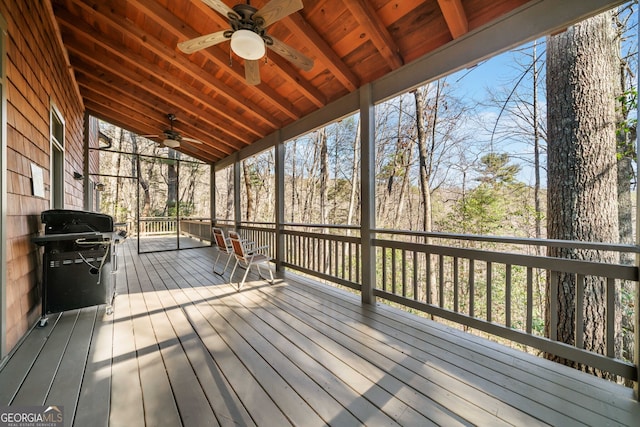 wooden deck featuring ceiling fan and area for grilling