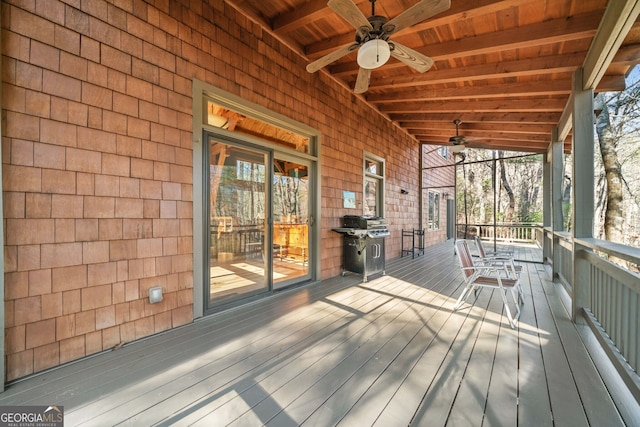 wooden deck featuring a ceiling fan and a grill