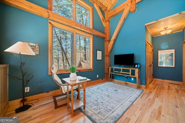 sitting room featuring high vaulted ceiling, wood finished floors, wood ceiling, and baseboards