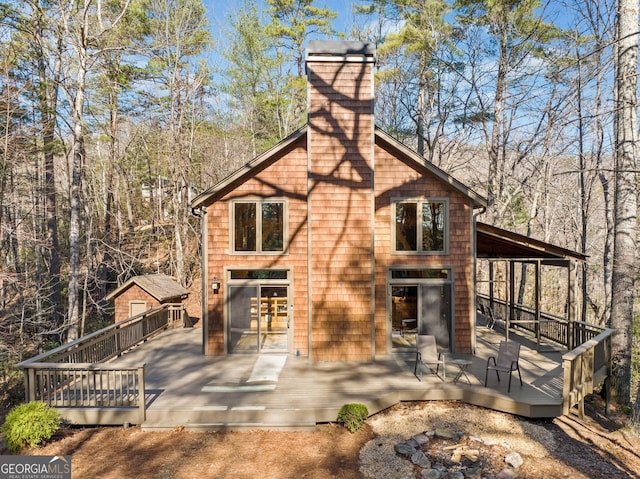 exterior space with a deck and a chimney