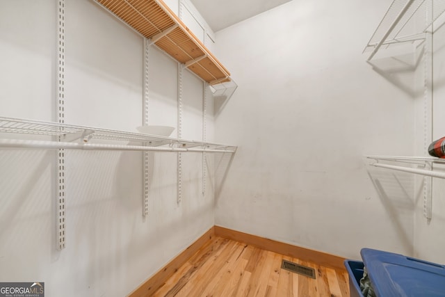 spacious closet with wood finished floors and visible vents