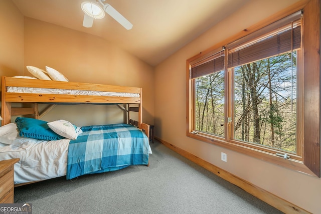 bedroom with carpet floors, ceiling fan, baseboards, and lofted ceiling