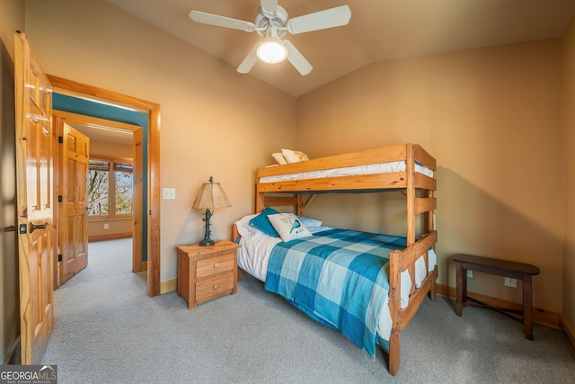 carpeted bedroom featuring vaulted ceiling, baseboards, and ceiling fan