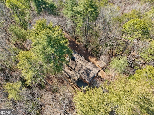 birds eye view of property with a wooded view