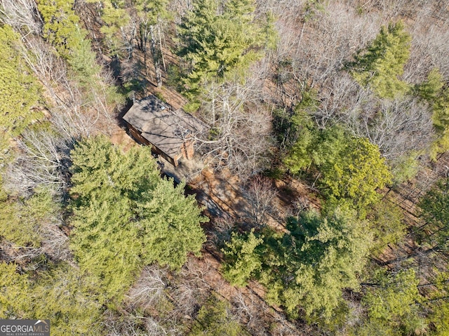 drone / aerial view with a wooded view