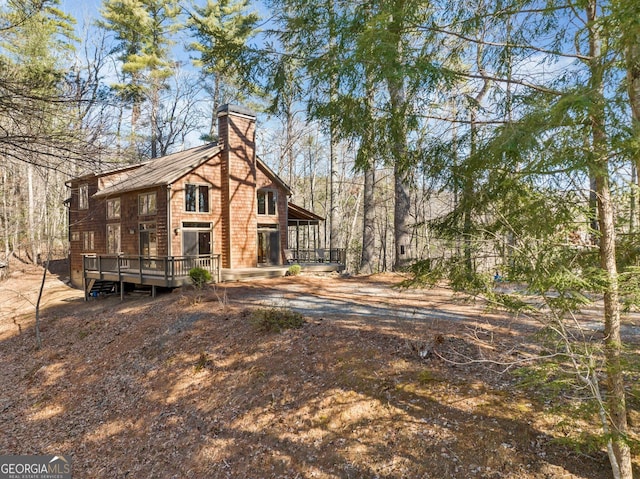 back of property with a chimney