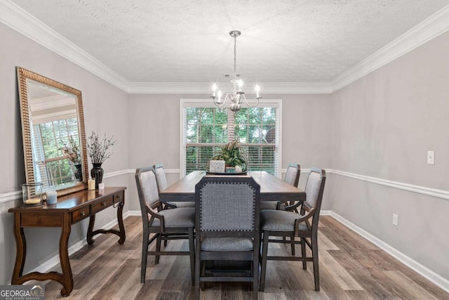 dining room featuring a textured ceiling, an inviting chandelier, and wood finished floors