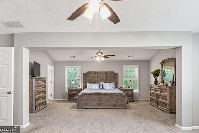 bedroom with light carpet, baseboards, multiple windows, and visible vents