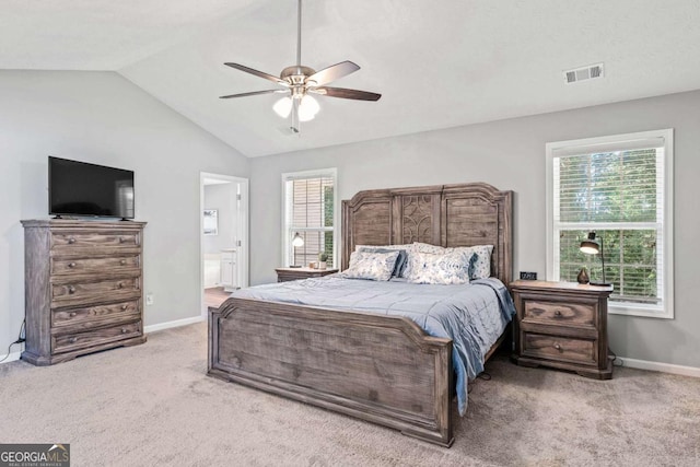 bedroom featuring lofted ceiling, multiple windows, light carpet, and visible vents