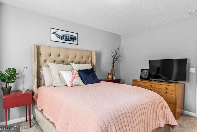 bedroom with light carpet, visible vents, baseboards, and a textured ceiling