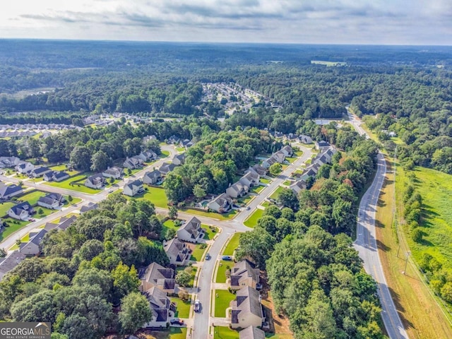 aerial view featuring a wooded view and a residential view