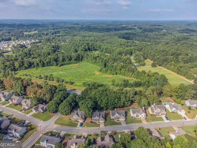 birds eye view of property featuring a residential view and a view of trees