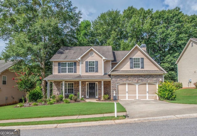 view of front facade with a front yard, stone siding, driveway, and a chimney