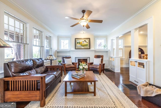 interior space with a ceiling fan, a wealth of natural light, and a fireplace