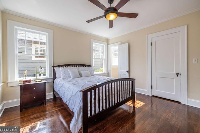 bedroom with dark wood-type flooring, ornamental molding, baseboards, and a ceiling fan