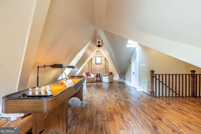 additional living space featuring lofted ceiling, baseboards, and wood finished floors