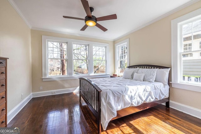 bedroom featuring crown molding, multiple windows, baseboards, and dark wood-style flooring