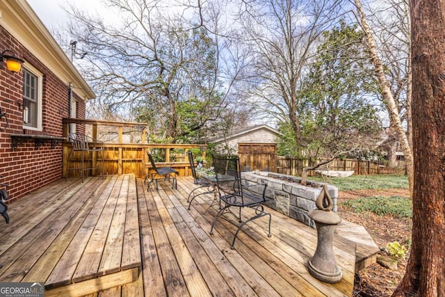 wooden deck with outdoor dining space and fence