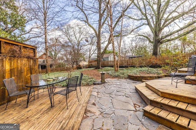 exterior space with a fenced backyard and outdoor dining space