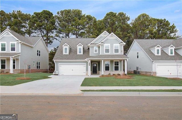 view of front of property featuring driveway, an attached garage, central AC unit, and a front yard