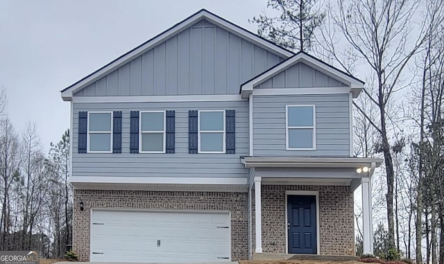 view of front of home with a garage, concrete driveway, brick siding, and board and batten siding