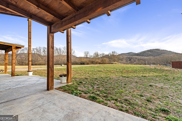 view of yard with a patio and a mountain view