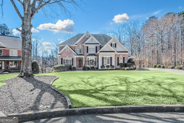 view of front of home featuring brick siding and a front lawn